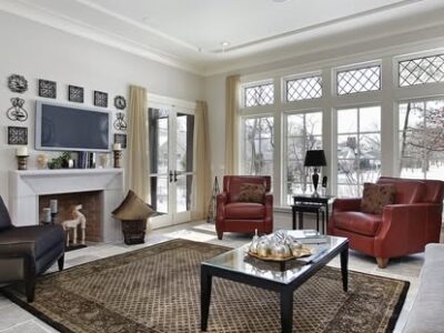 Family room in luxury home with wall of windows and fireplace